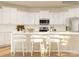 Bright kitchen with white cabinetry, stainless steel appliances, a kitchen island, and bar stool seating at 4194 Skyboat Cir, Fort Mill, SC 29715