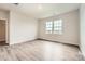 Bright bedroom featuring hardwood floors, two windows, neutral paint, and a walk in closet at 4222 Skyboat Cir, Fort Mill, SC 29715