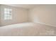 Bright bedroom featuring carpeted floors, neutral paint, and natural light from a window at 4222 Skyboat Cir, Fort Mill, SC 29715