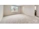 Spacious bedroom featuring carpeted floors, natural light, and an ensuite bathroom at 4222 Skyboat Cir, Fort Mill, SC 29715