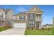 Charming two-story home featuring a mix of siding, attached two car garage, and a well-manicured lawn at 4222 Skyboat Cir, Fort Mill, SC 29715