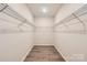Walk-in closet featuring wood floors, shelving units, and great storage space at 4222 Skyboat Cir, Fort Mill, SC 29715