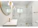 This bathroom has a glass shower, gold fixtures, and marble tile walls at 45 Mckinnon Ne Ave, Concord, NC 28025