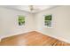 This bedroom has hardwood floors, white walls, and windows with tree views at 45 Mckinnon Ne Ave, Concord, NC 28025