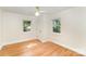 This bedroom has hardwood floors, white walls, and windows with tree views at 45 Mckinnon Ne Ave, Concord, NC 28025