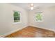 This bedroom has hardwood floors, white walls, and windows with tree views at 45 Mckinnon Ne Ave, Concord, NC 28025