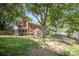 Classic brick home with mature trees, a screened porch, and a spacious front yard at 45 Mckinnon Ne Ave, Concord, NC 28025