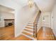Bright foyer with hardwood floors, a staircase, and a view of the living room at 45 Mckinnon Ne Ave, Concord, NC 28025