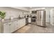 Well-lit kitchen with stainless steel appliances, granite countertops, and white cabinets at 45 Mckinnon Ne Ave, Concord, NC 28025
