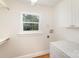 This laundry room features new white cabinets and a window that has tree views at 45 Mckinnon Ne Ave, Concord, NC 28025