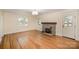 Inviting living room featuring a stone fireplace, hardwood floors, and neutral walls at 45 Mckinnon Ne Ave, Concord, NC 28025