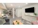 Open concept living room with modern decor, a large screen TV, and luxury vinyl plank flooring at 45 Mckinnon Ne Ave, Concord, NC 28025