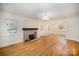 Spacious living room with hardwood floors, stone fireplace, and ample natural light at 45 Mckinnon Ne Ave, Concord, NC 28025