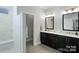 Elegant bathroom with a double vanity, framed mirrors, and a spacious walk-in shower at 4813 Reason Ct # 75, Harrisburg, NC 28075