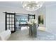 Elegant dining room with chandelier and sliding barn doors, perfect for entertaining guests at 4813 Reason Ct # 75, Harrisburg, NC 28075