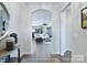 Inviting entryway featuring an arched opening, light gray walls, and views into the living room at 4813 Reason Ct # 75, Harrisburg, NC 28075