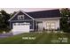 Charming two-story home with a two-car garage, landscaped yard, and covered front porch at 4813 Reason Ct # 75, Harrisburg, NC 28075