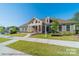 Community clubhouse with well-maintained landscaping and welcoming entrance with covered porch at 4825 Reason Ct # 73, Harrisburg, NC 28075