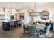 Open-concept dining area featuring a wooden table set for six, a decorative mirror, and stylish pendant lighting fixtures at 4825 Reason Ct # 73, Harrisburg, NC 28075