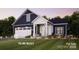 Charming single-Gathering home featuring a welcoming front porch and an attached two-car garage with beautiful landscaping at 4825 Reason Ct # 73, Harrisburg, NC 28075