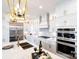Modern kitchen featuring white cabinetry, stainless steel appliances, a sleek island with bar seating, and pendant lighting at 4825 Reason Ct # 73, Harrisburg, NC 28075
