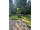 Lush backyard featuring a brick barbecue and mature trees, accessible from a wood deck perfect for entertaining at 5029 E Nc 10 Hwy Rd # 6, Catawba, NC 28609