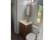 Bathroom featuring a wood vanity, toilet, framed mirror, and hard wood flooring at 5029 E Nc 10 Hwy Rd # 6, Catawba, NC 28609