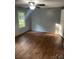 Bedroom featuring hard wood flooring, paneled walls, ceiling fan with lighting, and a window at 5029 E Nc 10 Hwy Rd # 6, Catawba, NC 28609