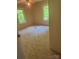 Bright bedroom features two windows, paneled walls, ceiling fan with lighting, and carpet flooring at 5029 E Nc 10 Hwy Rd # 6, Catawba, NC 28609