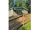 Accessible entrance with wooden ramp, green siding, awning, and a decorative quilt square at 5029 E Nc 10 Hwy Rd # 6, Catawba, NC 28609