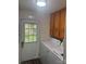 Bright laundry room with white appliances, oak cabinets, and a door with a window at 5029 E Nc 10 Hwy Rd # 6, Catawba, NC 28609