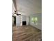 Open living room with beautiful hard wood flooring, a fire place with built-ins, and a large window at 5029 E Nc 10 Hwy Rd # 6, Catawba, NC 28609