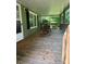 Covered front porch features wood flooring, green siding, shutters, and two wood rocking chairs at 5029 E Nc 10 Hwy Rd # 6, Catawba, NC 28609