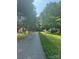 Scenic street view showcasing tree-lined driveway leading to a home with a double carport and storage shed at 5029 E Nc 10 Hwy Rd # 6, Catawba, NC 28609