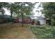 View of the backyard with a deck, lush landscaping, and a charming outdoor setting at 516 Northgate Ave, Charlotte, NC 28209