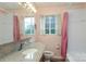 Bathroom features a granite counter top and large mirror, with a bright window view at 516 Northgate Ave, Charlotte, NC 28209