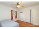 This bedroom features a ceiling fan, hardwood flooring, and natural light at 516 Northgate Ave, Charlotte, NC 28209