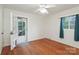 Bedroom with hardwood floors and natural light provided by large window and glass panel door at 516 Northgate Ave, Charlotte, NC 28209