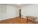 Neutral bedroom featuring hardwood floors, built-in shelves, and fresh paint at 516 Northgate Ave, Charlotte, NC 28209