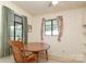Cozy dining area featuring a table and two windows with custom curtains at 516 Northgate Ave, Charlotte, NC 28209