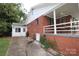 Exterior of a brick home with a covered porch, white trim, and a well-maintained yard at 516 Northgate Ave, Charlotte, NC 28209
