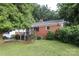 A quaint single-story brick home with a well-maintained lawn and mature trees at 516 Northgate Ave, Charlotte, NC 28209