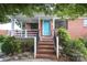Charming brick home with a cozy front porch and a bright blue front door at 516 Northgate Ave, Charlotte, NC 28209