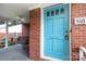 Close-up of the blue front door and porch swing of a brick home at 516 Northgate Ave, Charlotte, NC 28209