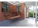 A comfortable front porch with a wooden swing and detailed brickwork at 516 Northgate Ave, Charlotte, NC 28209