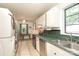 Traditional kitchen features white cabinets, green countertops, stainless appliances and washer/dryer at 516 Northgate Ave, Charlotte, NC 28209