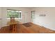 Sunny living room with original hardwood floors and a large window at 516 Northgate Ave, Charlotte, NC 28209