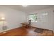 Bright living room with hardwood floors and natural light from a large window at 516 Northgate Ave, Charlotte, NC 28209