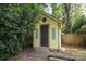 Backyard shed surrounded by lush greenery with access via wood ramp at 516 Northgate Ave, Charlotte, NC 28209