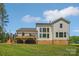 Expansive backyard with a large deck, ideal for relaxation and outdoor activities, complemented by a lush green lawn at 545 Morrison Farm Rd, Troutman, NC 28166